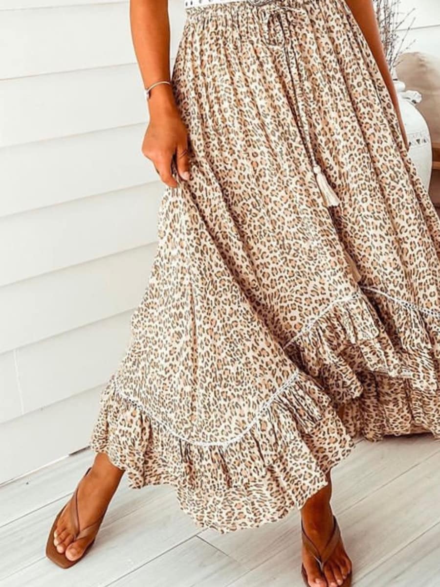 Leopard Nomad Skirt in lightweight rayon with ruched elastic waist, button-down front, tassel ties, and floaty hem.